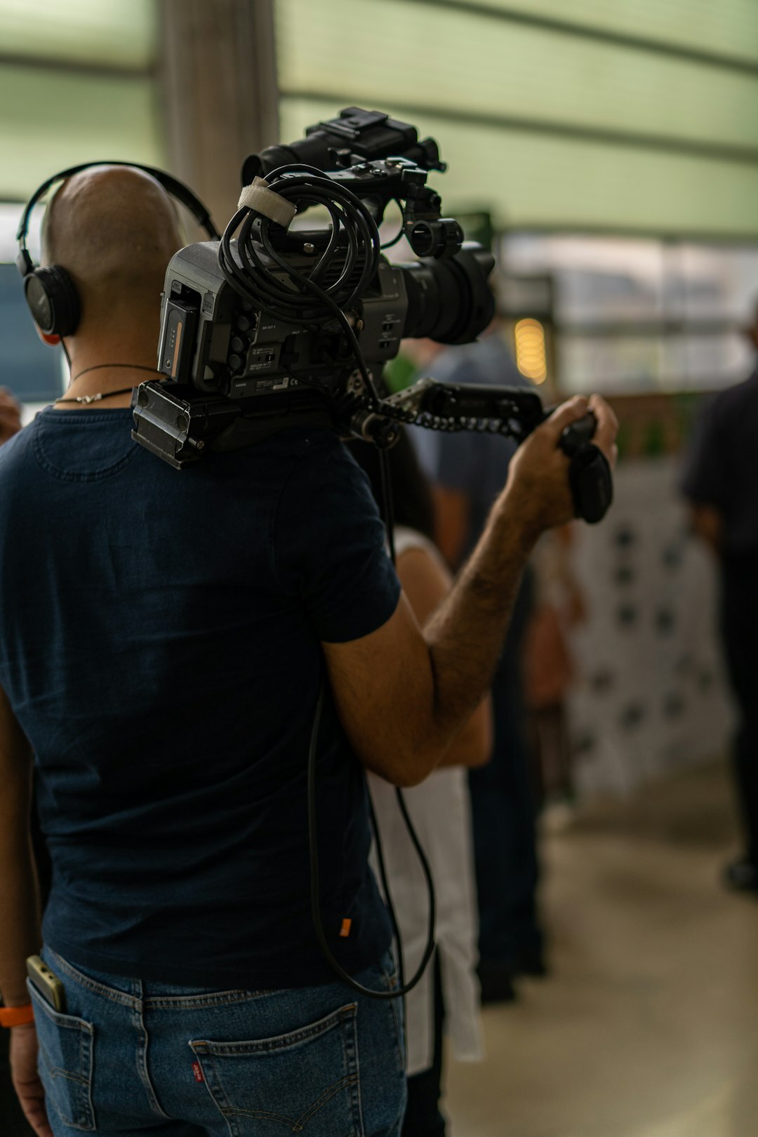 Journalist reporting live on location with a microphone and camera operator