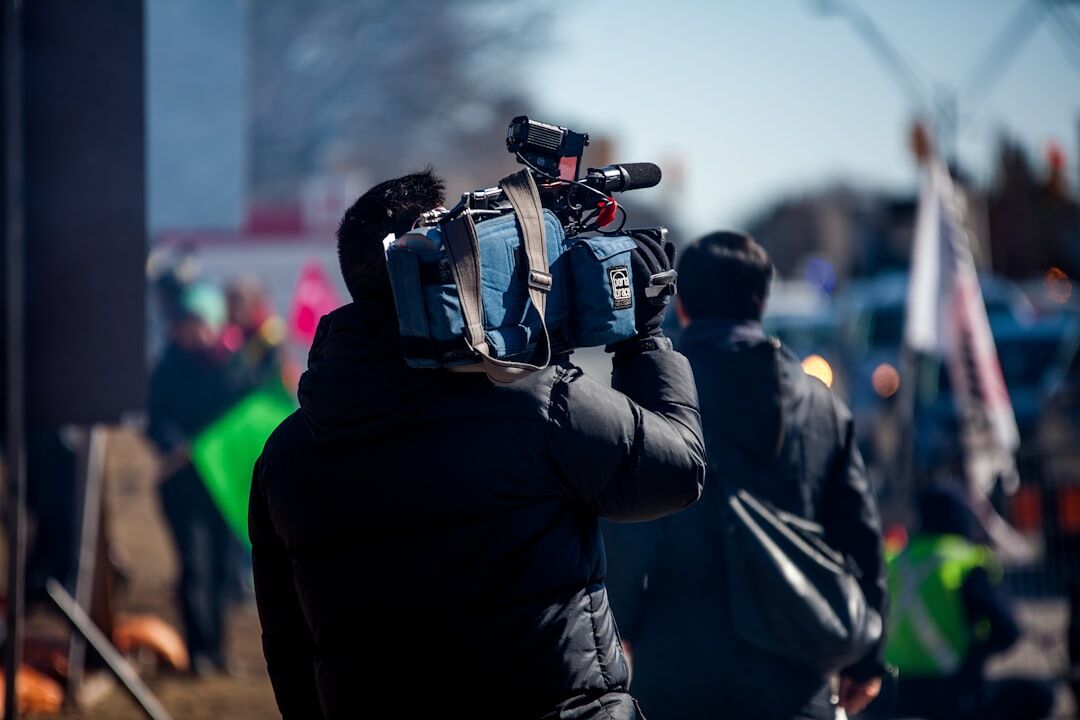 Camera crew filming an interview outdoors in a city