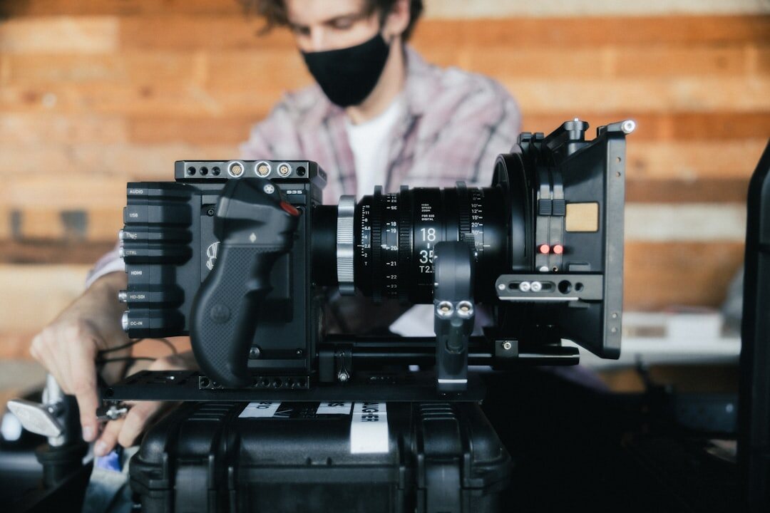 Camera operator filming with a professional broadcast camera
